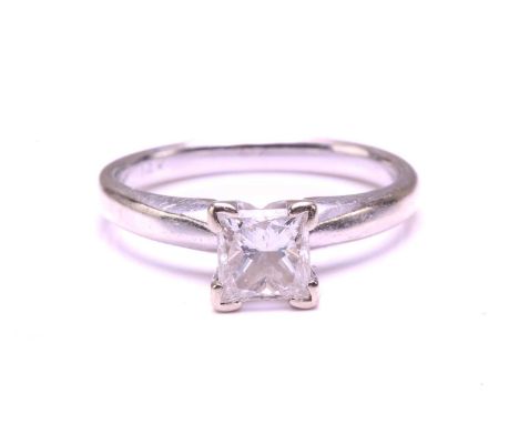 A single-stone diamond ring. The princess cut diamond in raised four claw mount. The diamond is estimated to be F/G colour, a