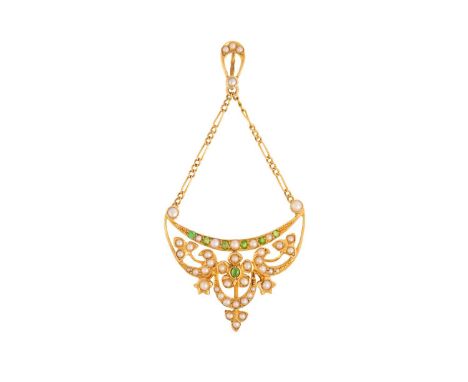 An Edwardian demantoid garnet and seed pearl pendant, of floral design, the scrolled openwork mount has set with split pearls