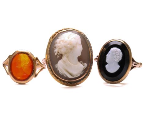 Two cameo rings and an intaglio ring; to include an oval onyx cameo ring, depicting a side profile of a male, set within a co