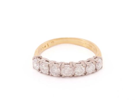 A diamond half eternity ring, comprising seven brilliant-cut diamonds, approximately measuring 3.3 x 3.3 x 2.2 mm, claw set i