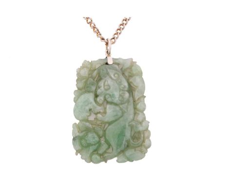 A carved jade pendant, in rectangular form, depicting a stylised ox amidst lotus flowers, attached to a white metal loop bail
