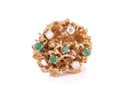 A Modernist dress ring in 9ct gold, comprising four circular-cut emeralds and three diamonds, claw set on an organically scul