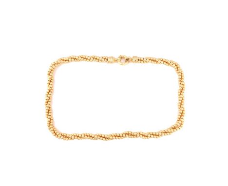 A bead torsade necklace in yellow metal, fastened with a thick spring-ring clasp, Italian hallmarked as '750', measuring 45.5