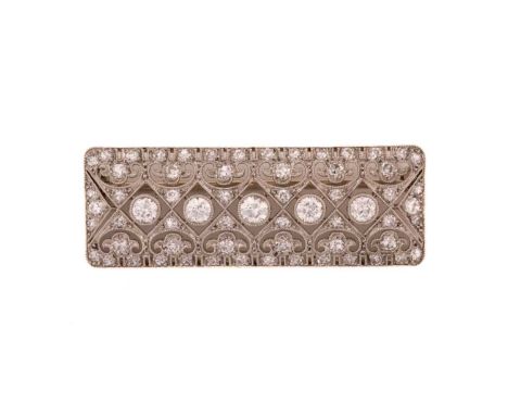 An Edwardian diamond bar brooch, composed of five larger round old-European cut diamonds set in millgrained collets, confined