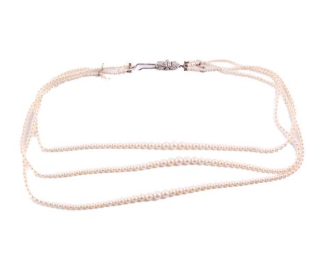 A three-row pearl necklace, comprising three strands of round pearls graduating from 2.5 mm to 5.9 mm, on silk thread attachi