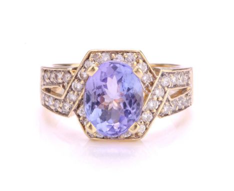 A tanzanite and diamond dress ring, centrally set with oval faceted tanzanite with a light bluish-purple colour, approximatel