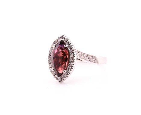 A tourmaline and diamond cluster ring; the marquise-shaped tourmaline set within a border of round brilliant cut diamonds, to