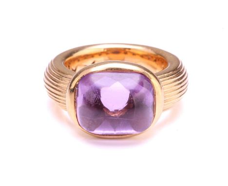 An amethyst dress ring in 18ct yellow gold, comprising a rectangular buff-top amethyst with a faceted pavilion, approximately