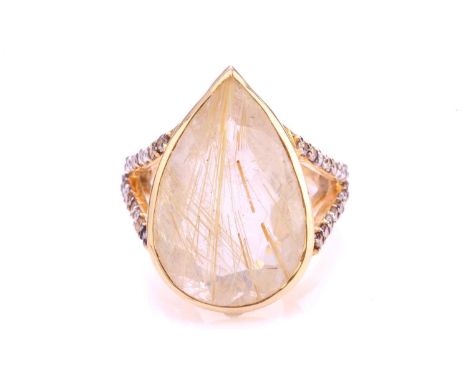 A rutilated quartz dress ring, featuring pear-shaped faceted quartz of 21.4 x 13.9 mm, with yellow rutile crystal inclusions,