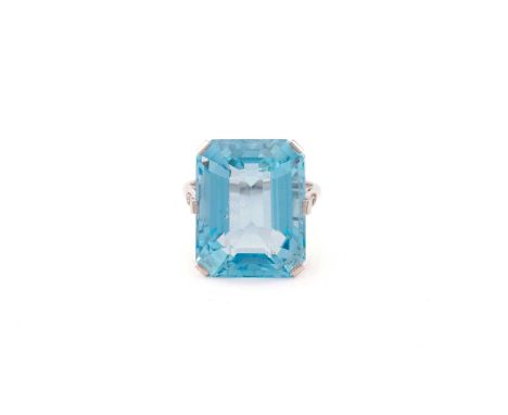 A large aquamarine dress ring, featuring an emerald-cut aquamarine in vivid sky blue colour, approximately measures 18.7 x 14