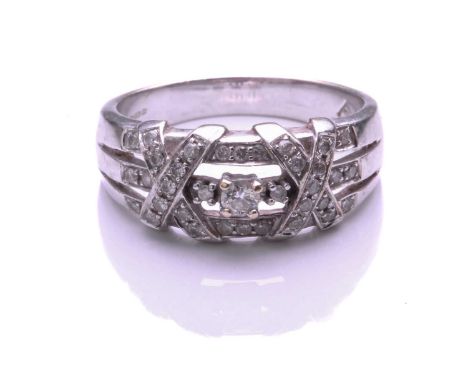 A 9 carat white gold and diamond ring, the central round brilliant cut diamond within a three row diamond set frame, with dia