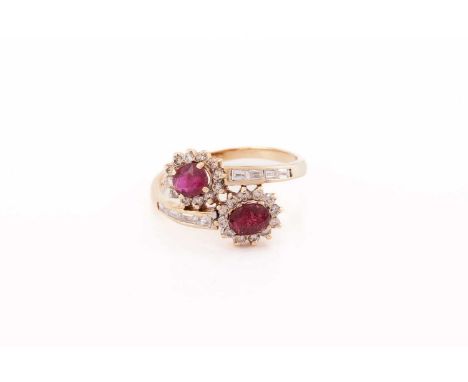 A ruby and diamond bypass ring, composed of two clusters of oval faceted rubies surrounded by brilliant-cut diamonds on a byp