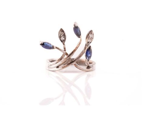 A sapphire and diamond spray ring; the crossover mount with five strands, three terminating in marquise shaped sapphires and 