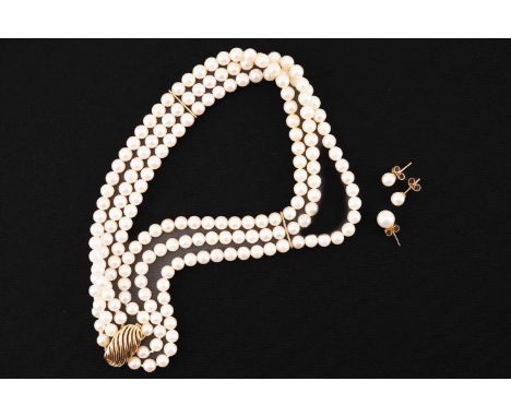 A three-strand pearl choker and three pearl stud earrings; The necklace comprises three rows of round cream-coloured pearls w