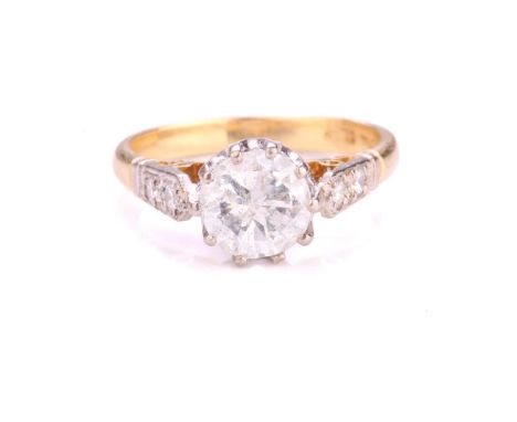 A diamond solitaire ring in 18ct yellow gold, consisting of a circular brilliant-cut diamond in a high-profile coronet settin