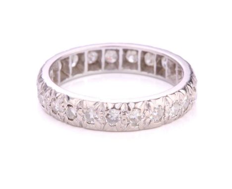 A diamond eternity ring in platinum, illusion-set with an array of circular single-cut diamonds, London hallmarked '950' with