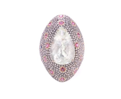 A cocktail ring with beryl, diamonds and garnets, comprising large pear-shaped beryl with a pale green colour, approximately 