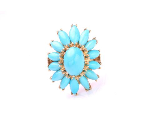 A turquoise flowerhead ring, comprises a high-domed turquoise cabochon claw set in the centre, surrounded with elongated marq