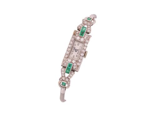 An Art Deco lady's watch set with diamonds and emeralds stamped 'platinum', featuring a swiss made hand-wound movement in a w