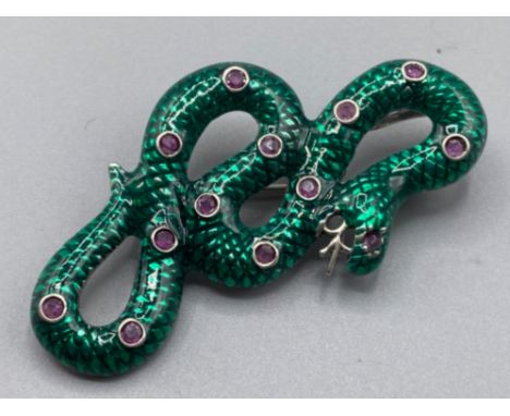 A silver and enamel set snake brooch-pendant set with Ruby cabochons