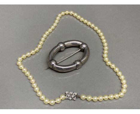 Cultured Pearl necklace together with a white metal scarf brooch