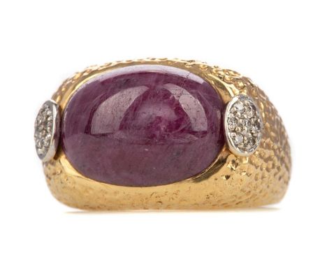 RUBY AND DIAMOND RING,set with cabochon ruby measuring 16x11.8mm, with pave set diamond terminals, to a hammered shank marked