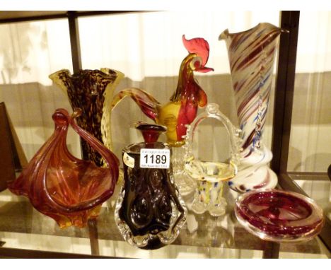 Shelf of coloured glass including Murano 