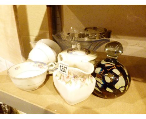 Shelf of mixed items including Mdina paperweight