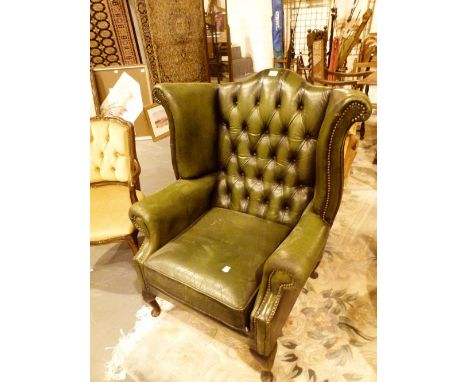 Green leather Chesterfield style armchair with button back