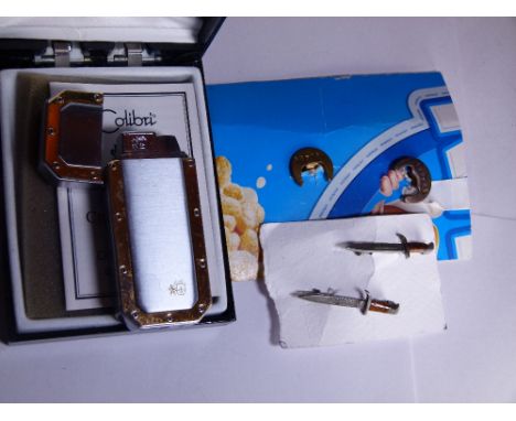 Boxed Colibri cigarette lighter and cigar cutter plus British Legion badges and two Bezeion knife badges