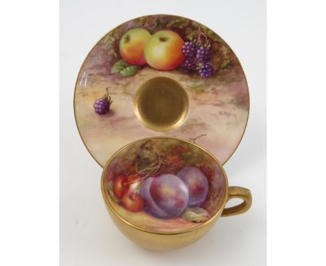 A Royal Worcester miniature cabinet cup and saucer, the saucer hand painted with fruit to a mossy background by W Hale, dated