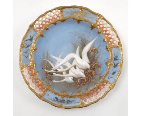 A Royal Worcester cabinet plate, decorated with three swans in flight with gilt reeds to a powder blue ground by C Baldwyn, w