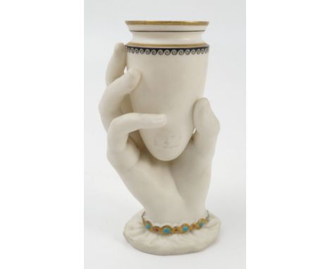 A Royal Worcester parian vase, the vase supported in a hand, with gilt and jewelled bracelet and cuff, dated 1865, printed an