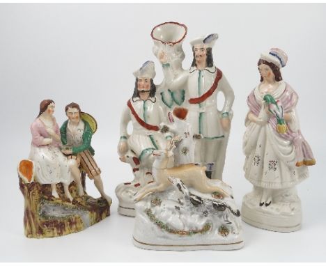 A 19th century Staffordshire figure group, of a man and woman seated on a rocky base, height 9ins, together with a 19th centu