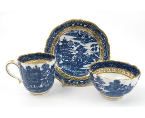 A 18th century Caughley trio, the cup, tea bowl and saucer printed in blue and white with a version of the Willow pattern, wi