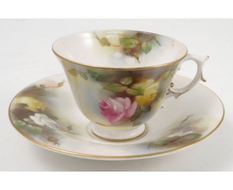 A Royal Worcester tea cup and saucer, decorated with pink, yellow and white roses, dated 1912 Condition report: good conditio