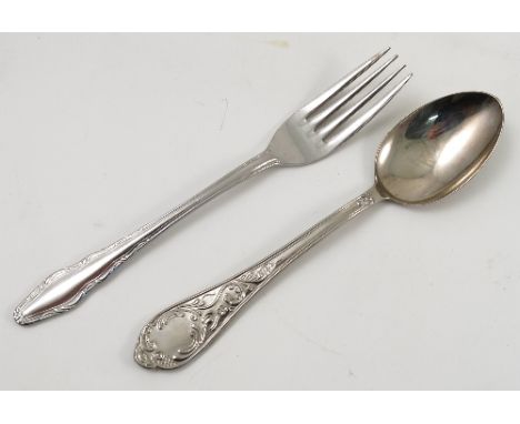 A Continental white metal part canteen of cutlery, decorated with scrolling flowers and lattice, comprising eight forks, eigh
