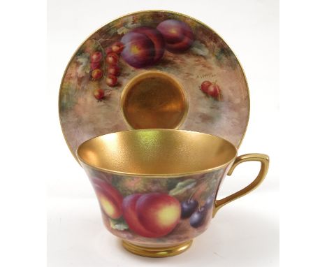 A Royal Worcester cabinet cup and saucer, hand painted to the exterior of the cup and the saucer with fruit to a mossy backgr