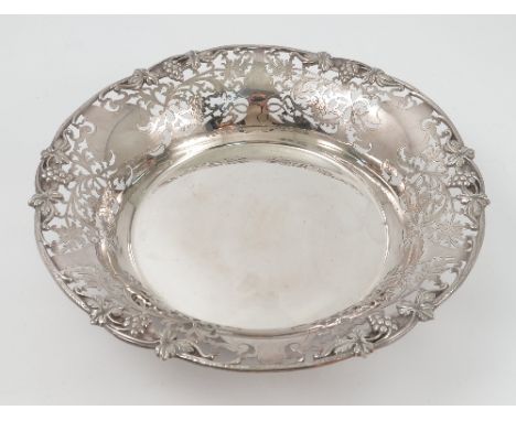 A silver fruit bowl, by Mappin and Webb, Sheffield, 1971, of circular outline, being pierced and engraved with fruiting vine 