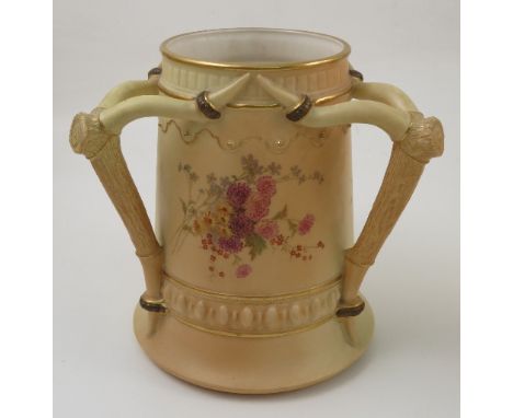 A Royal Worcester blush ivory three handled loving mug, the handles modelled as deer antlers, with moulding and floral sprays