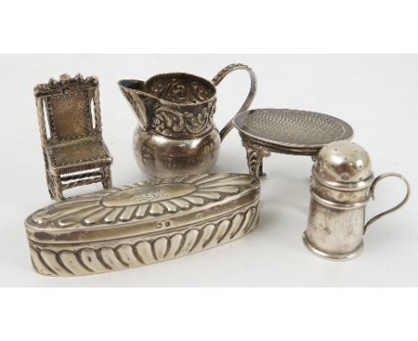 A collection of hallmarked silver, to include a miniature table, two miniature chairs, a pair of shell shaped salts, a pierce