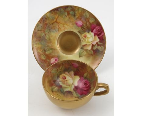 A Royal Worcester cabinet cup and saucer, hand painted with roses to the interior and exterior of cup, dated 1951 Condition r