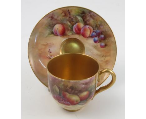 A Royal Worcester cabinet cup and saucer, the saucer and exterior of cup hand painted with fruit to a mossy background by Bag