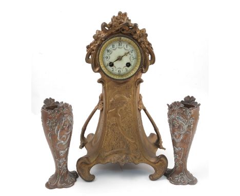 An Art Nouveau metal clock garniture, the clock with striking movement stamped BTG, with white enamel dial decorated with flo