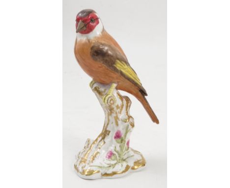 A Royal Worcester model, Goldfinch, on a gilt and white stump decorated with flowers, model number 2667 Condition report: goo