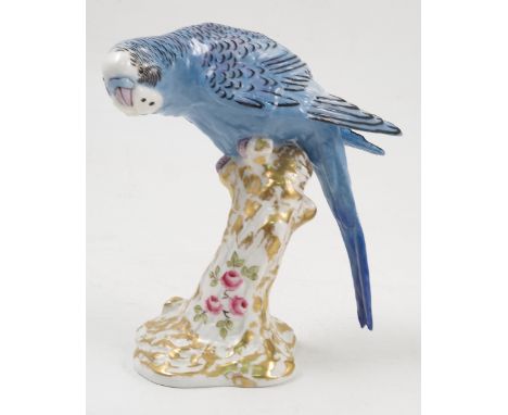 A Royal Worcester model, male Paroquet, in blue, on a gilt and white stump decorated with flowers, model number 2664 Conditio
