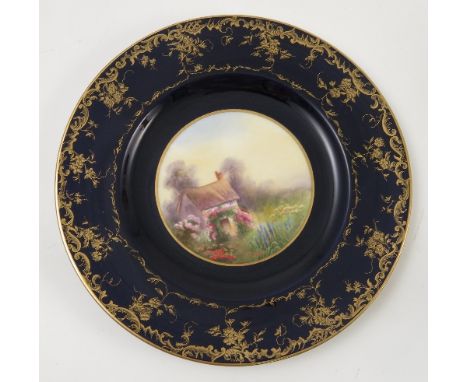 A Royal Worcester cabinet plate, hand painted with a cottage and flower garden, by Ball?, to a deep blue and gilt border, dat
