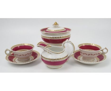 A 19th century English porcelain part tea service, decorated in bands of gilt and red, comprising a covered sugar bowl, milk 