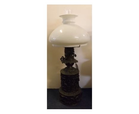 Victorian early embossed metal oil lamp with opaque shade, 21ins tall  