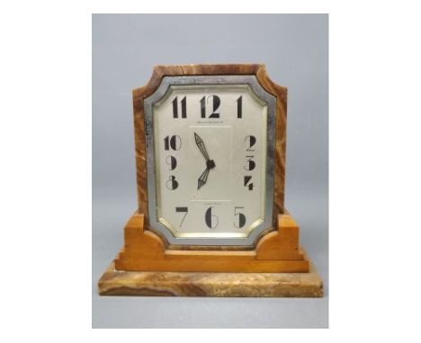 Art Deco Waring & Gillow Ltd mantel clock of square form with an onyx case raised on a stepped onyx and mahogany plinth, 8 1/